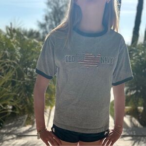 This is an old navy gray T-shirt with black out line.